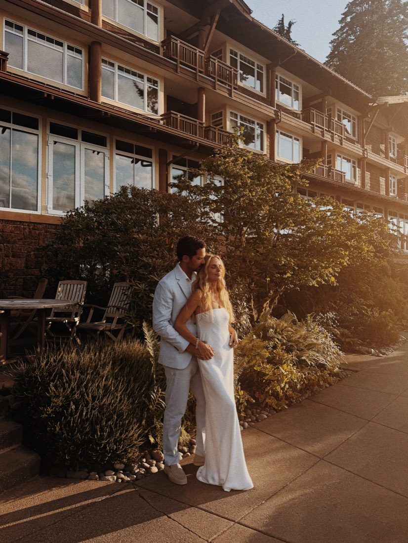 Katie and Danny holding each other outside Alderbrook in low evening sun