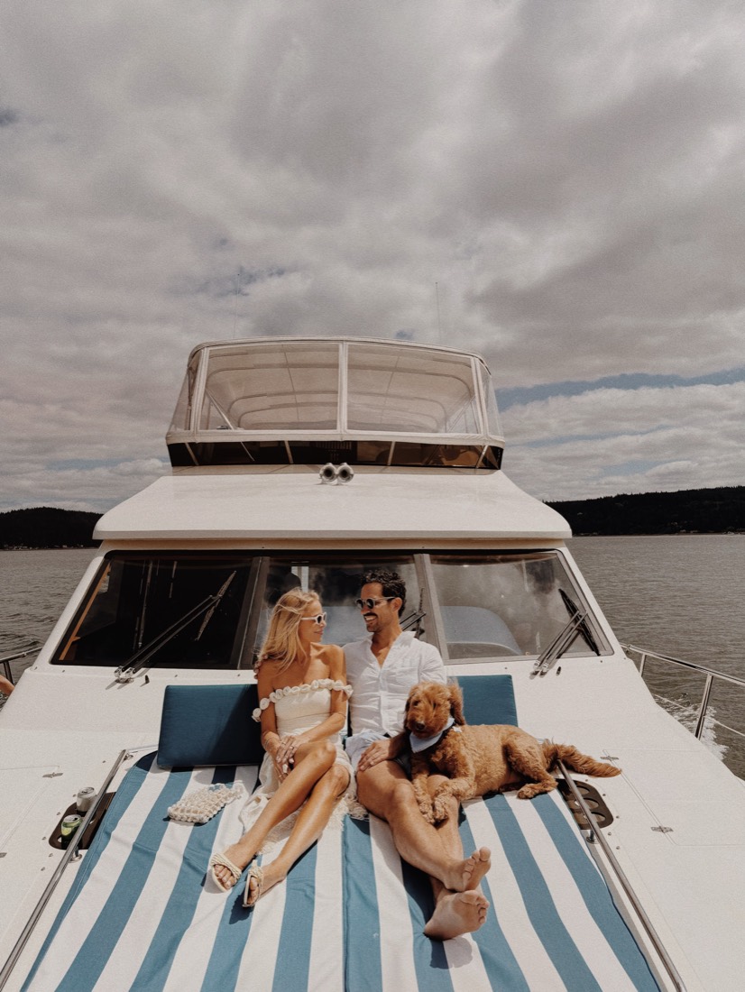 Katie and Danny on the bow of the boat with both dogs