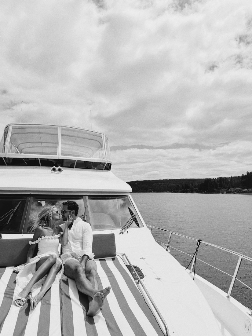 The two of them lying on the bow of the boat, in black and white