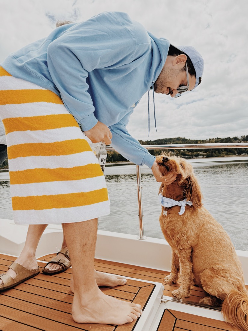 A striped dress and the golden retriever on the teak deck of the boat