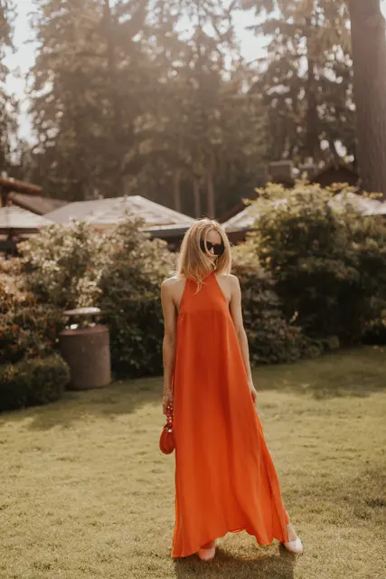 A guest in an orange dress outside Alderbrook