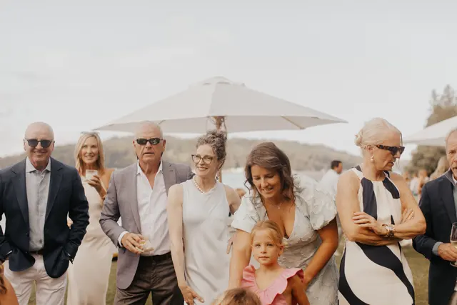 Family and friends gathered by the water