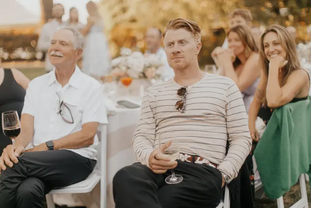 Friends listening to the wedding speeches