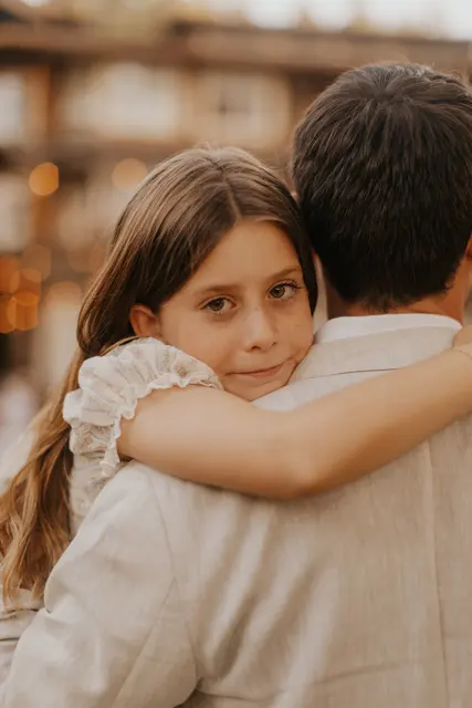 A child hugging her dad at the reception