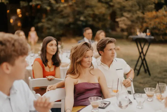 Family listening to speeches at the reception