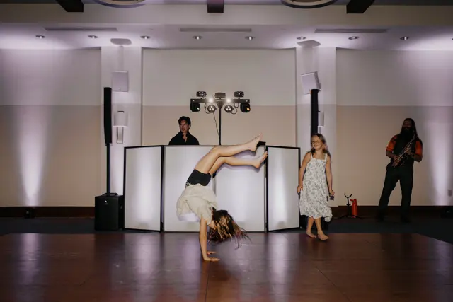 A child dancing in front of the DJ