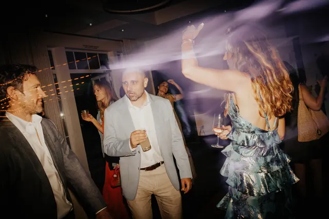Friends celebrating under the dance-floor lights