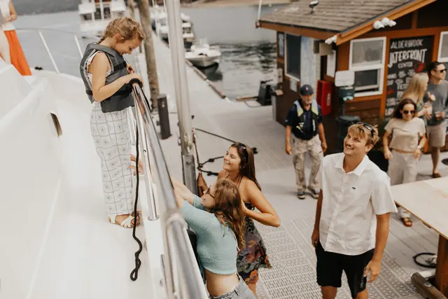 Guests stepping off the boat onto the dock