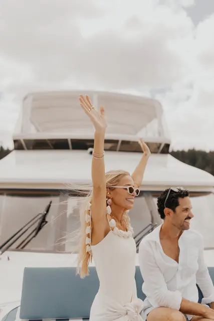 Katie and Danny waving from the bow