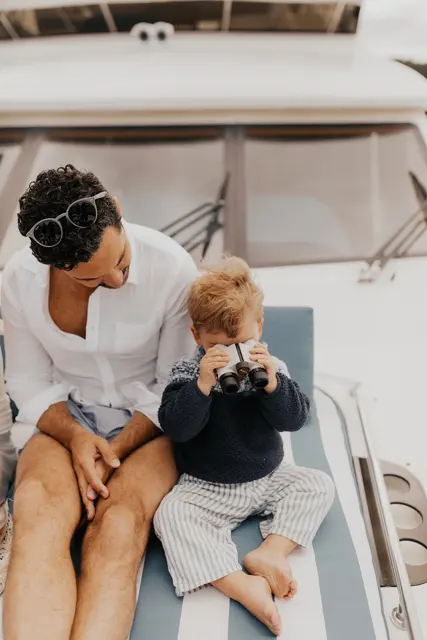 Danny sitting with a child on the bow