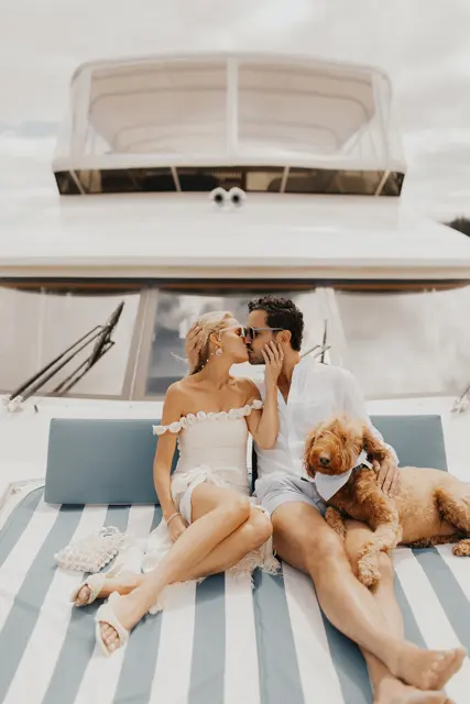 Katie and Danny relaxing on the bow with family and the dogs