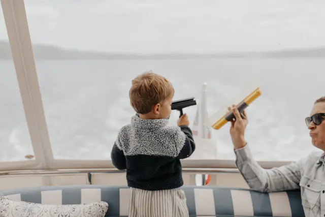A child using binoculars on deck