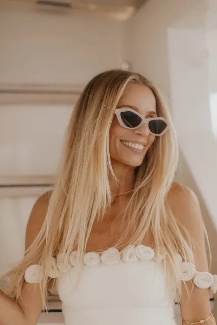 Katie in her wedding dress and sunglasses aboard the boat