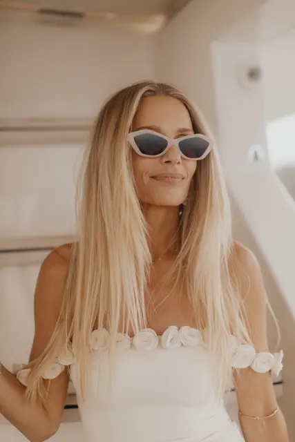 Katie in her wedding dress and sunglasses aboard the boat