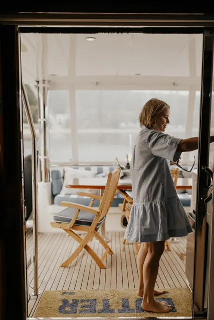 Katie standing in the boat cabin