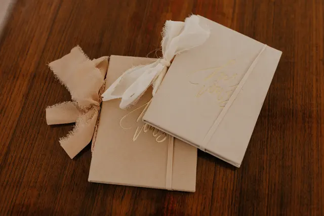 Wedding vow books on a wooden table