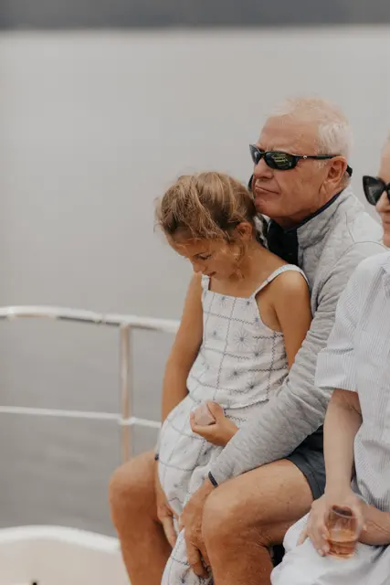 A child sitting with a guest on the boat