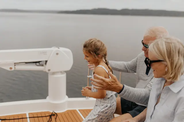 Family watching the ceremony from the boat