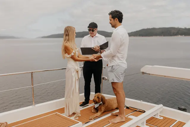 Katie and Danny with their officiant on the aft deck