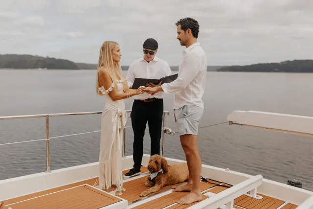 Katie and Danny holding hands during the ceremony