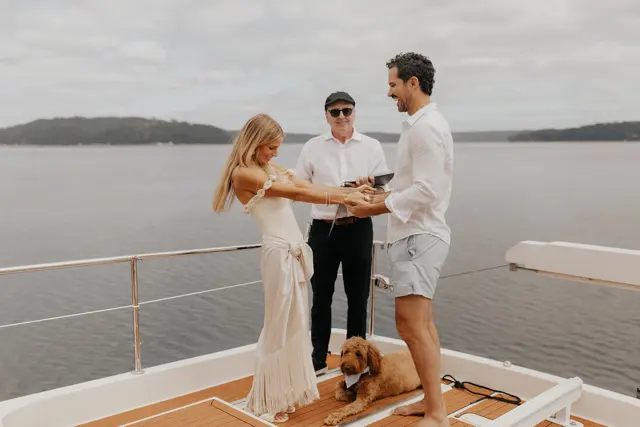 Katie and Danny holding hands during the ceremony