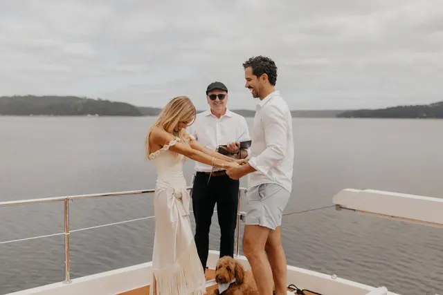 Katie and Danny holding hands during the ceremony