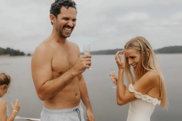 Katie and Danny celebrating with champagne